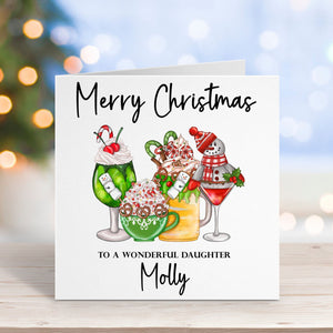 Christmas card with cocktails and text on a wooden surface with blurred lights in the background
