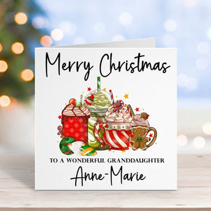 Christmas card for a granddaughter with hot chocolate mugs and festive text on a blurred Christmas background.