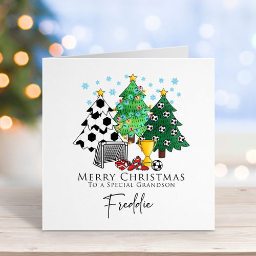 Christmas card with festive design on a wooden surface with blurred lights in the background