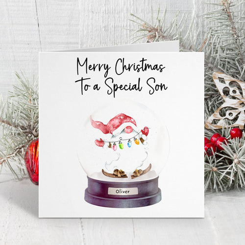 Christmas card with a snow globe featuring a Santa Claus figure and text 'Merry Christmas to a Special Son'.