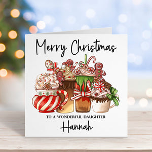 Christmas card with festive illustrations and personalized text on a blurred Christmas tree background.