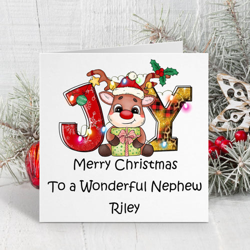Christmas card with reindeer and 'JOY' letters on a white background with decorative elements.