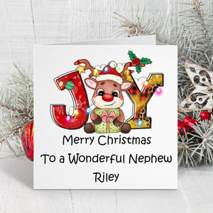 Christmas card with reindeer and 'JOY' letters on a white background with decorative elements.