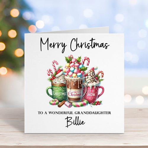 Christmas card with hot chocolate mugs and candy canes on a wooden surface with blurred lights in the background