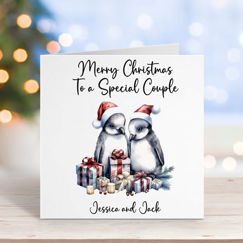 Christmas card with penguins and personalized text on a blurred background
