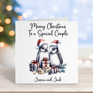 Christmas card with penguins and personalized text on a blurred background