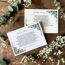 Two personalised Esme wedding gift poem cards with sage eucalyptus corners, fine borders and black lettering, displayed on wood with greenery and white flowers.”