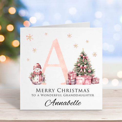Christmas card with a snowy scene and personalized text on a blurred festive background