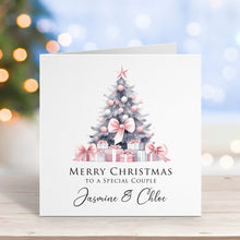 Christmas card with a tree and presents on a blurred festive background