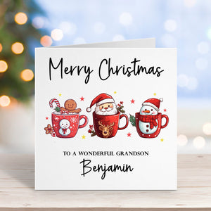 Christmas card with Santa, reindeer, and snowman design on a wooden surface with blurred lights in the background.