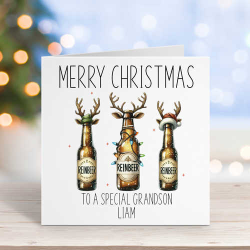 Christmas card with reindeer-themed beer bottles on a wooden surface with blurred lights in the background