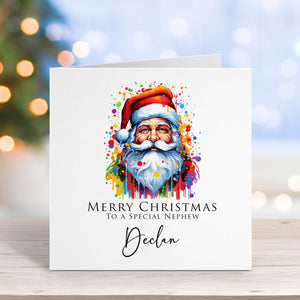 Christmas card with watercolor Santa Claus design on a wooden surface with blurred lights in the background