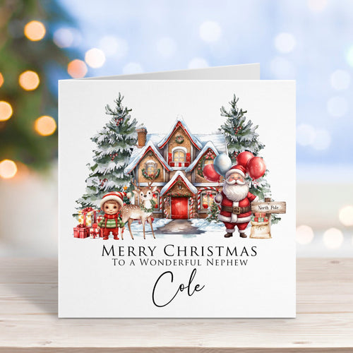 Christmas card with Santa Claus and a house on a wooden surface with blurred lights in the background